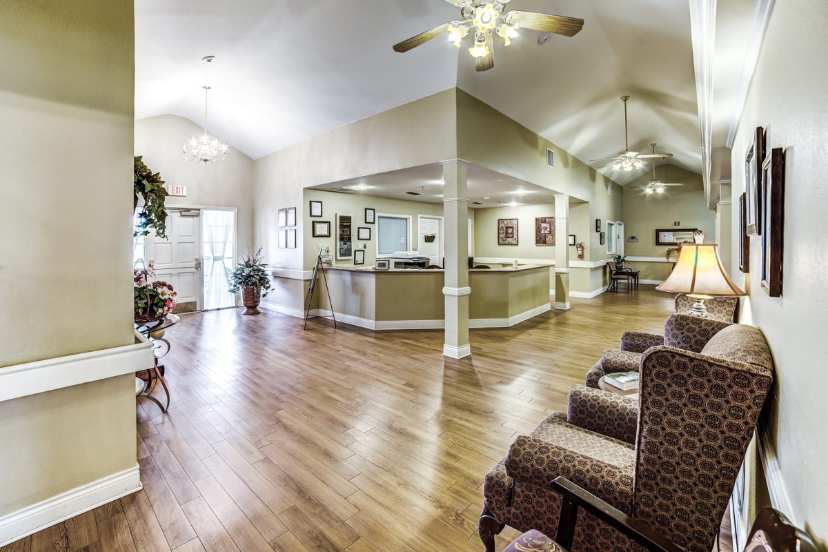 Spacious reception area with comfortable seating and wooden flooring.