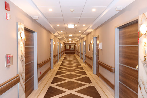 A well-lit, modern hallway featuring elegantly designed doors and a stylish floor pattern.
