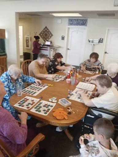 A group of elderly individuals enjoying a bingo game together at a community center.