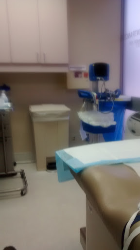 A view of a medical examination room with equipment ready for patient use.