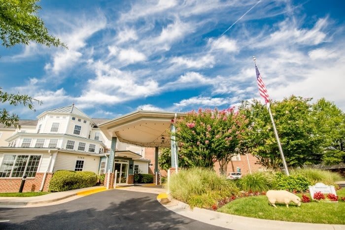 Entrance to a healthcare facility with clear skies.