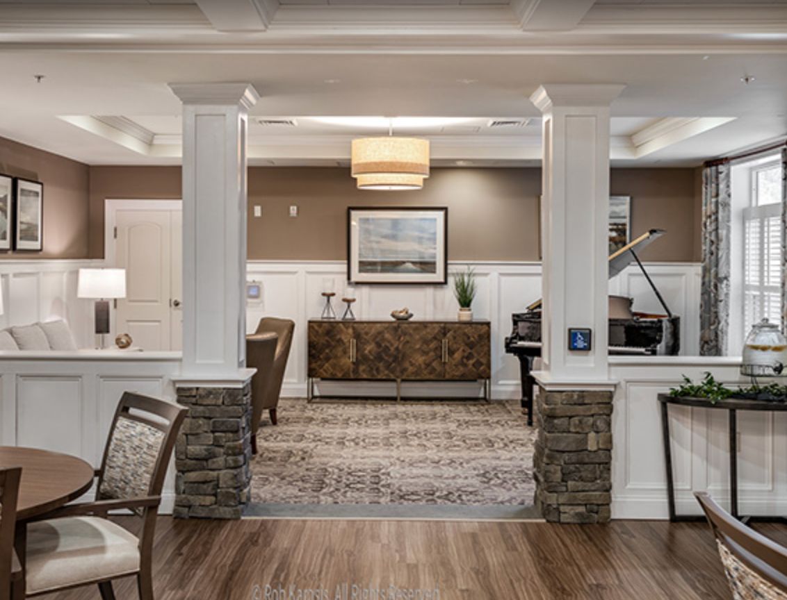 Elegant living space featuring a piano, cozy seating, and tasteful decor.