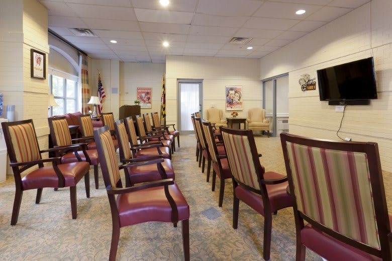 An empty waiting room with rows of chairs in a well-lit interior.
