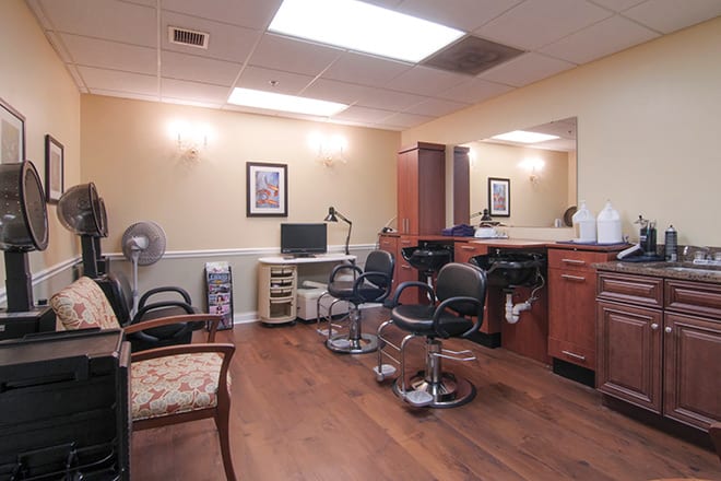 A cozy hair salon with barber chairs and mirrors.