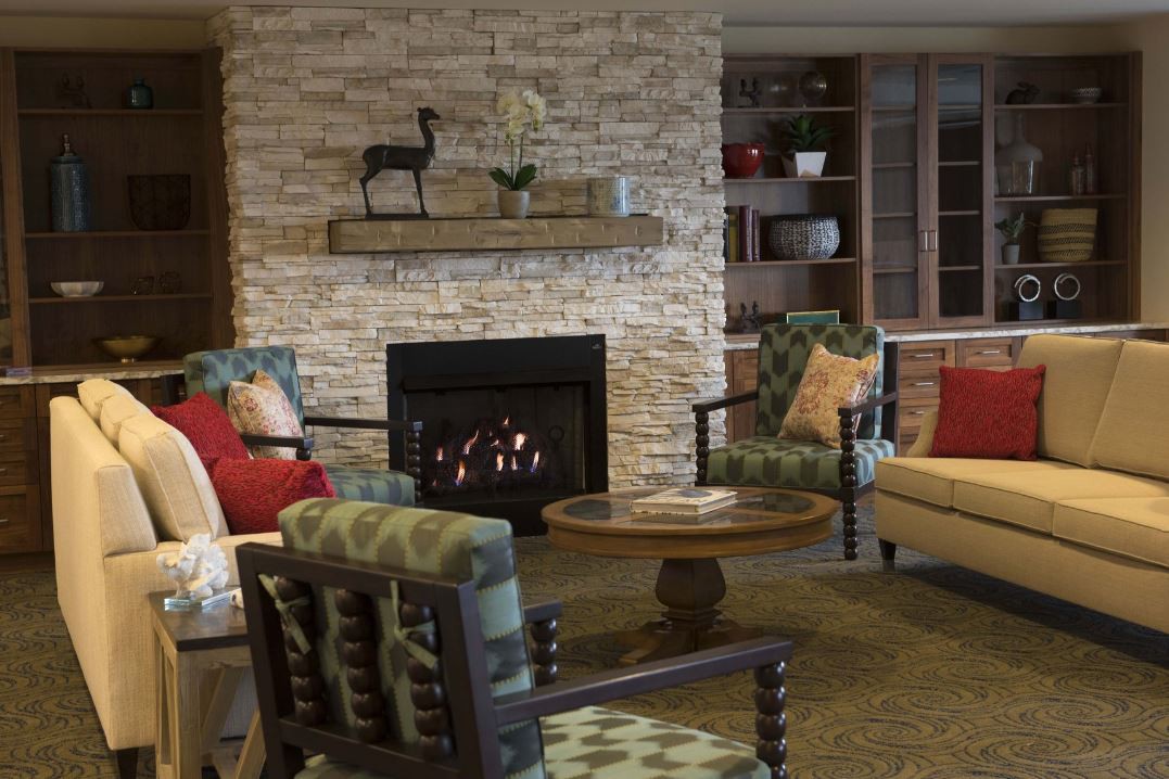 Cozy living room with a stone fireplace and comfortable seating.