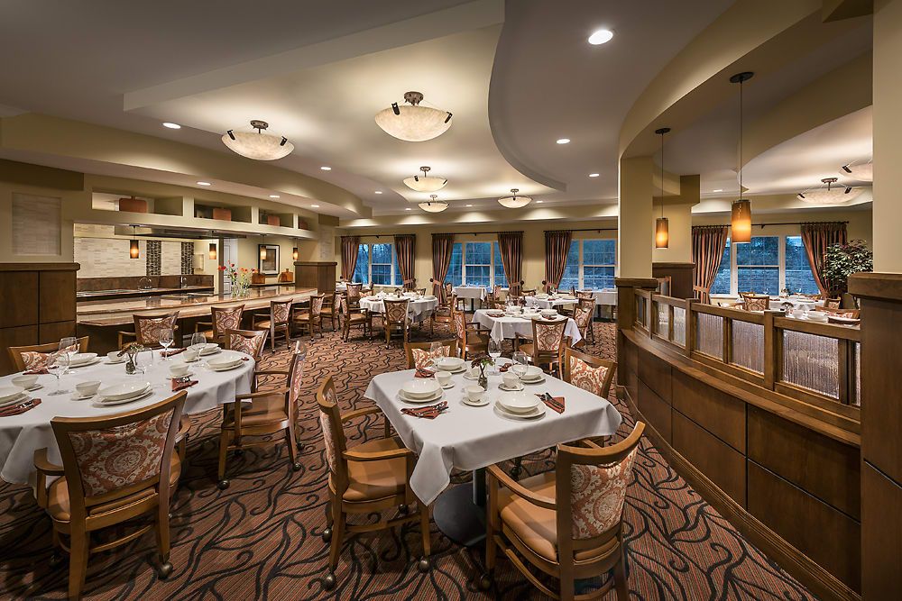 Elegant restaurant interior with neatly arranged dining tables and soft lighting.
