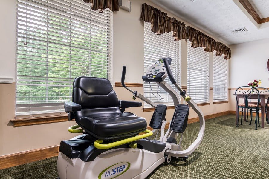 A recumbent exercise bike in a well-lit indoor gym setting.