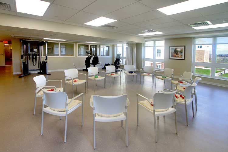 An empty waiting room with chairs arranged in a circle.