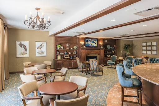 A cozy lounge area featuring comfortable seating, a fireplace, and elegant decor.