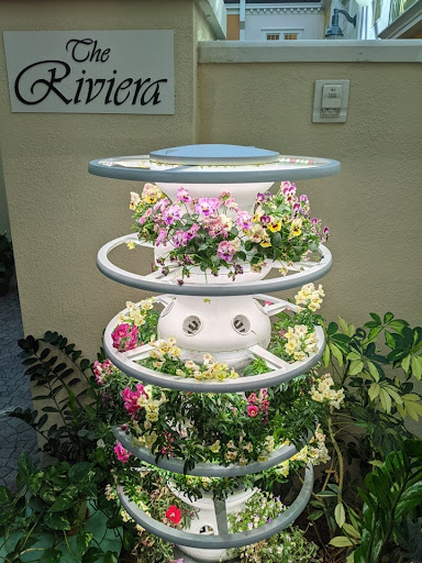 A unique vertical planter filled with colorful flowers, adding charm to the garden.