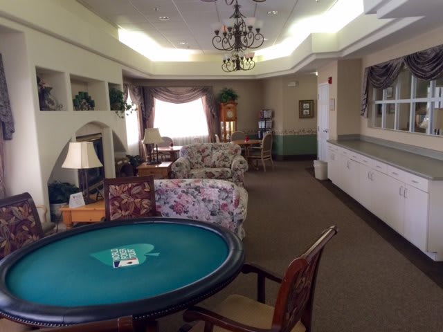 A cozy lounge area with a poker table and comfortable seating.