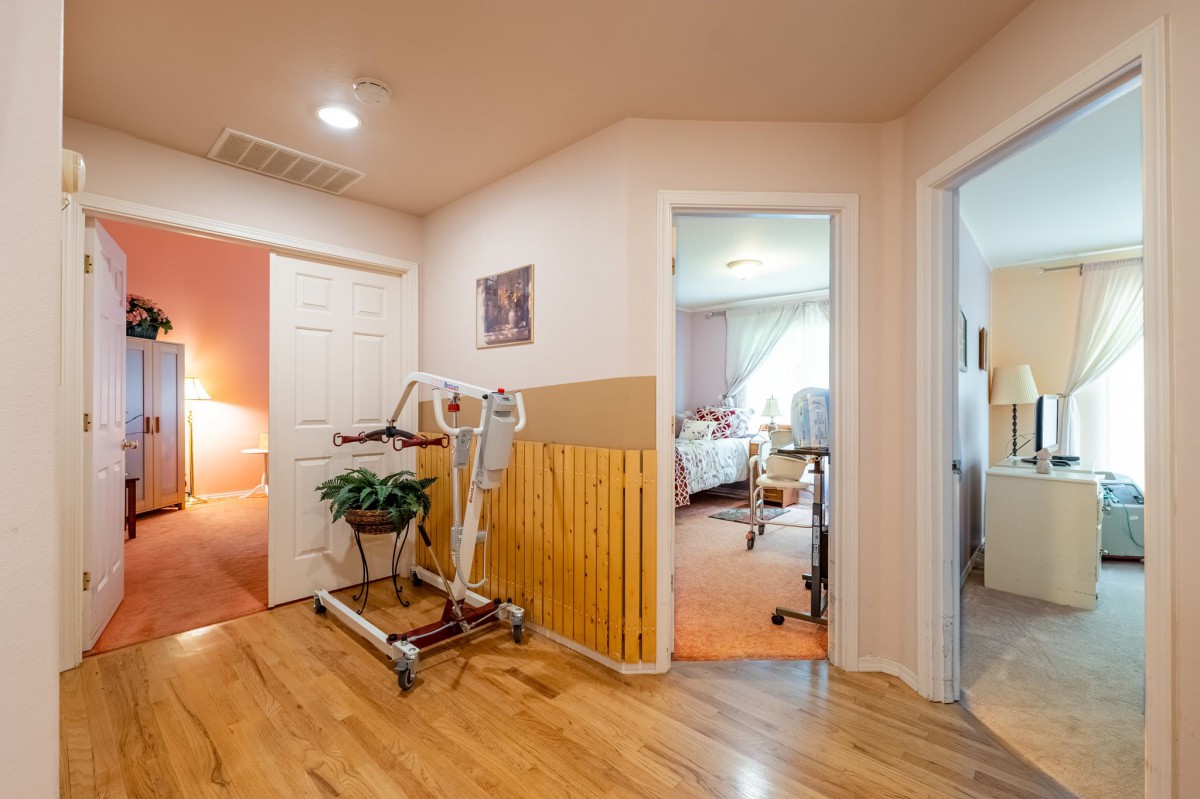 A hallway with medical equipment and adjacent bedrooms.