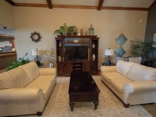 A cozy living room with two sofas, a coffee table, and an entertainment center.