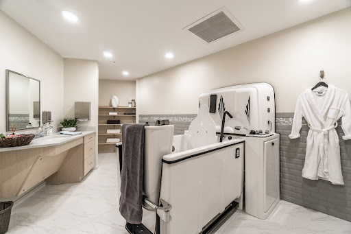 A stylish and functional modern bathroom featuring a laundry area and contemporary fixtures.
