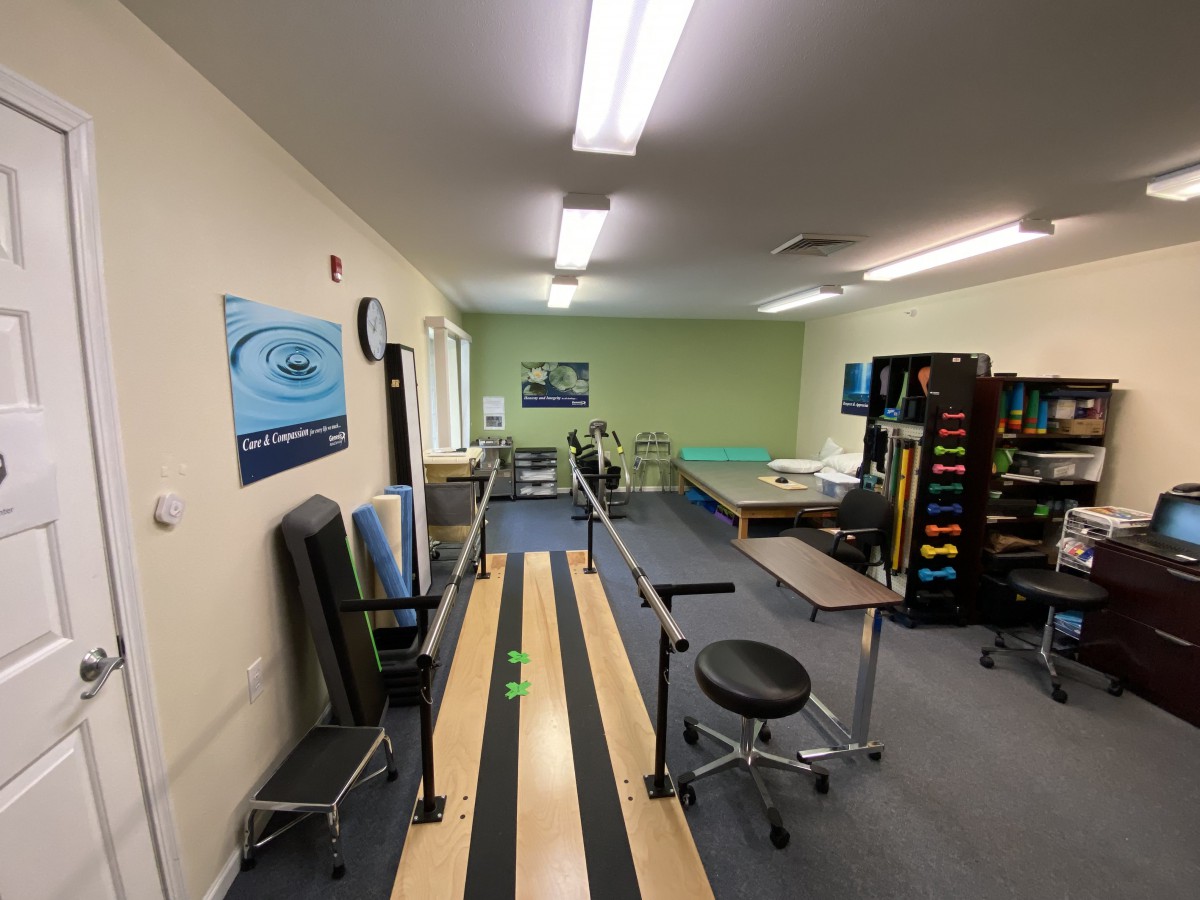 A physical therapy room equipped with various rehabilitation tools and treatment areas.