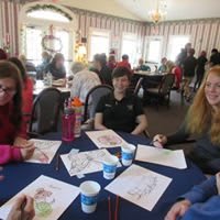 A group of people sitting around a table engaged in an activity.
