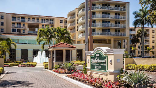 The entrance to a luxurious hotel resort with landscaped gardens and modern architecture.
