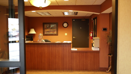 A cozy reception area with warm tones and standard office furnishings.