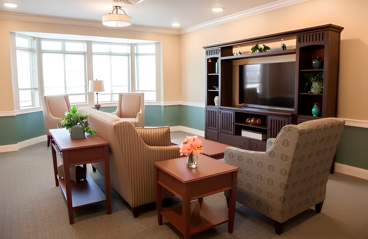 A cozy living room with comfortable seating, a large television, and tasteful decor.