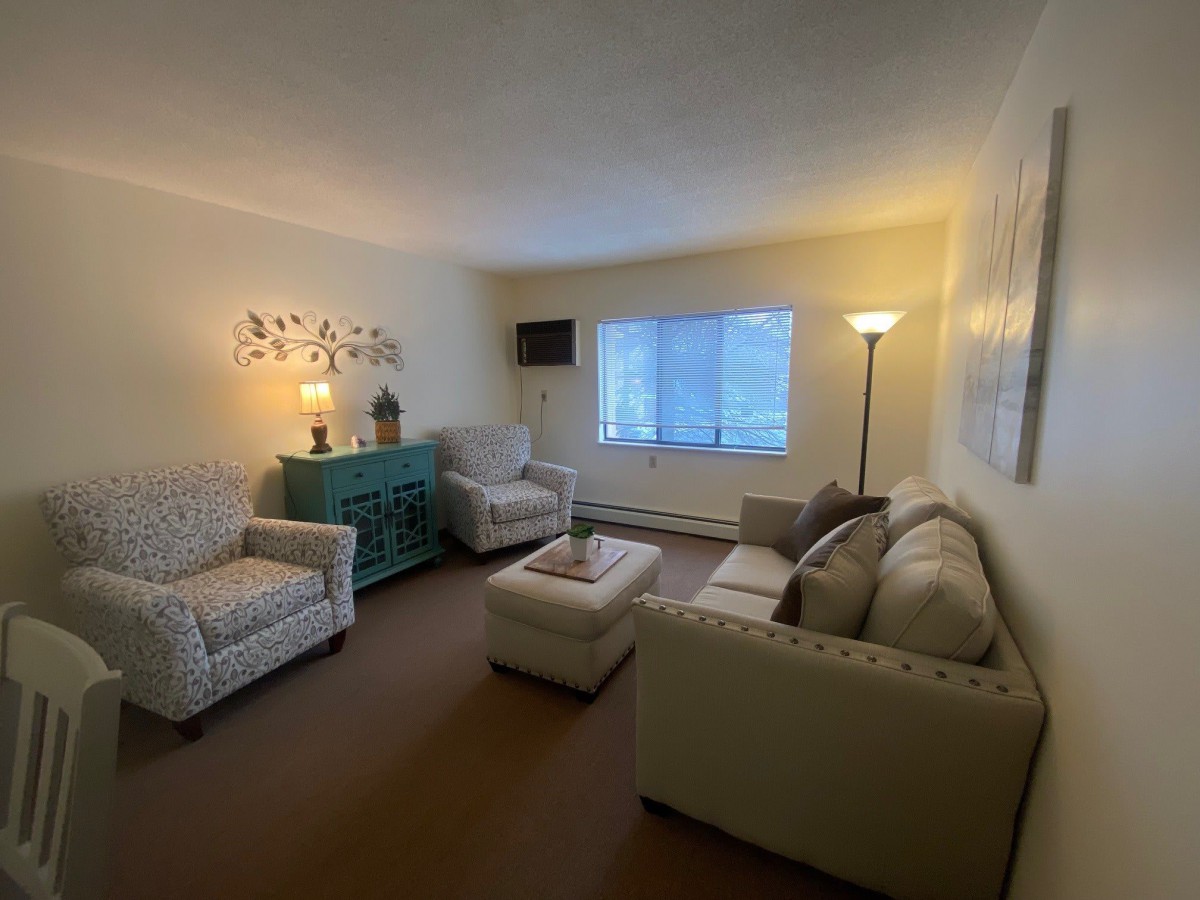 A cozy living room with comfortable seating and warm lighting.