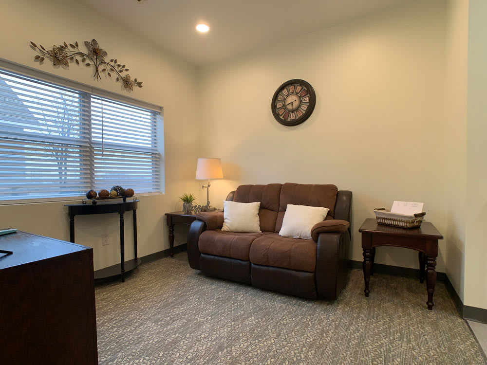 Cozy living room with a brown sofa, soft lighting, and decorative elements.