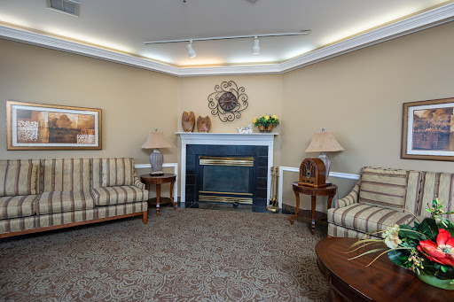 A cozy living room setup featuring striped sofas and a welcoming fireplace.