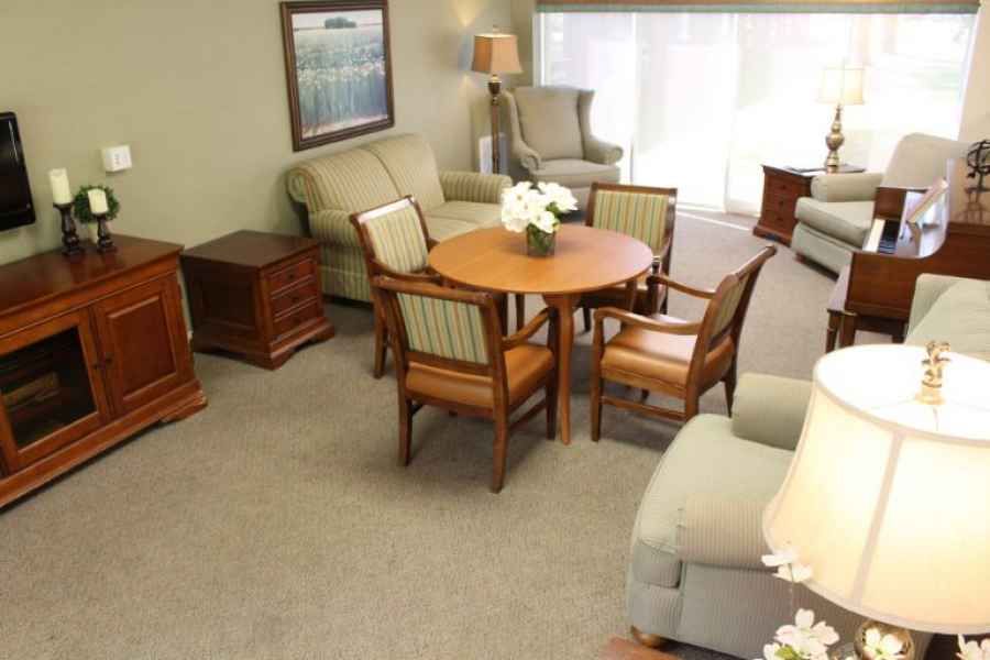 A cozy living room with comfortable seating and a round wooden table.