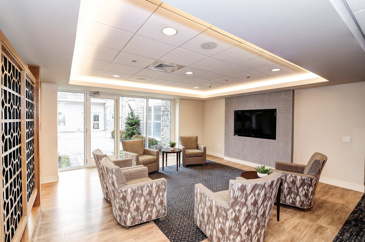 A modern living room with comfortable seating and a large television.