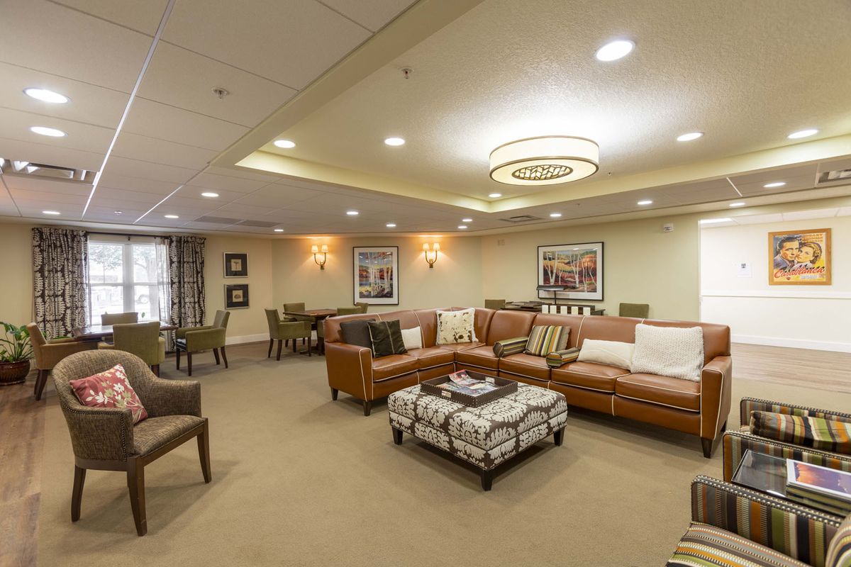 A cozy and elegantly furnished living room with comfortable seating, modern lighting, and tasteful decor.