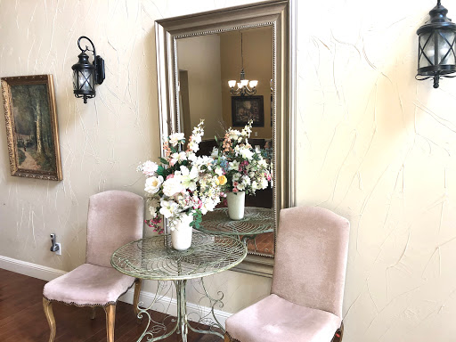 A charming corner with a floral centerpiece and elegant seating, reflected beautifully in the mirror.