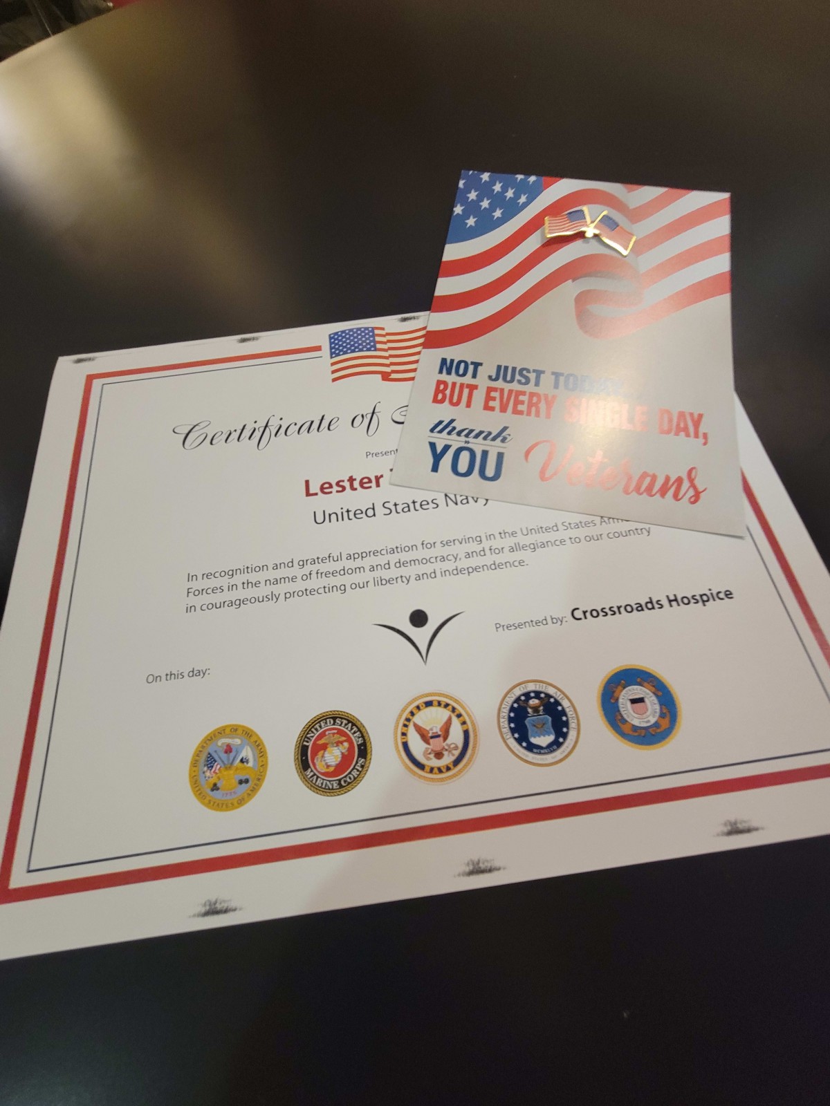 A certificate of appreciation featuring the American flag and military seals.