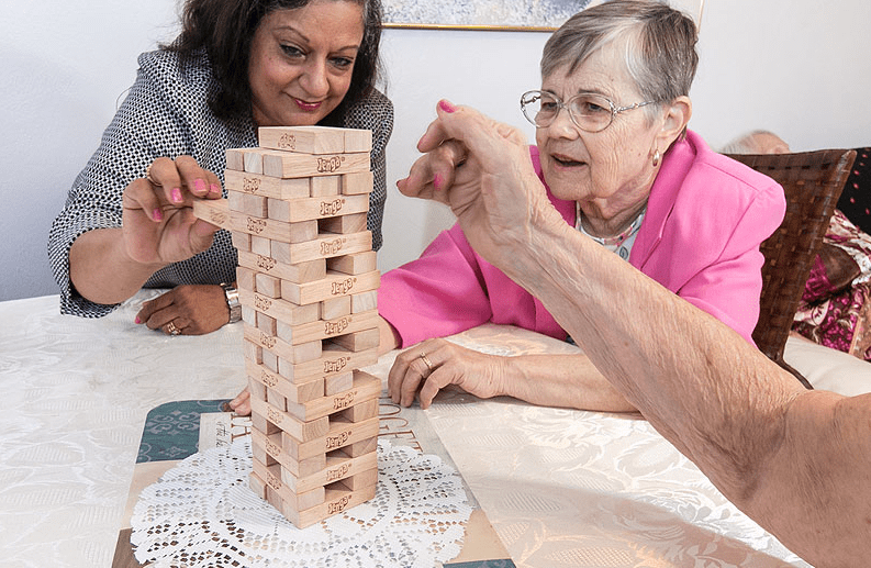 Seniors enjoying a game of Jenga.