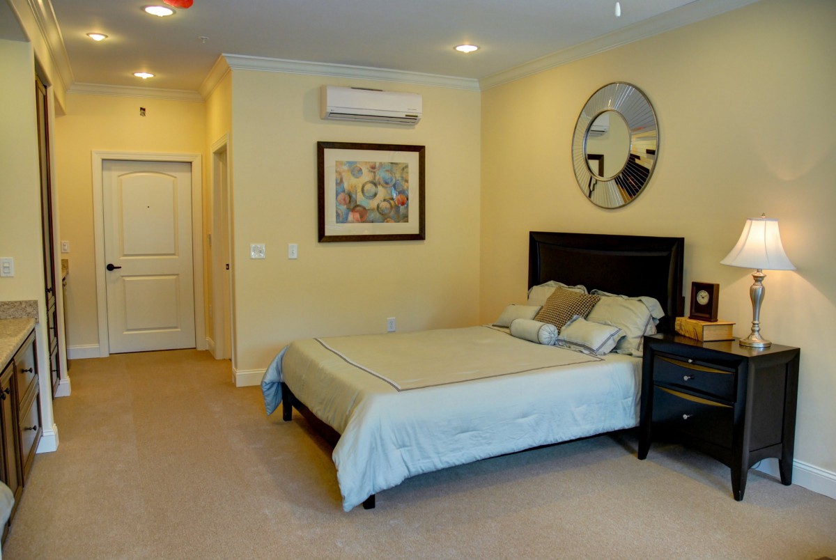 A cozy and well-decorated bedroom with a double bed and nightstand.