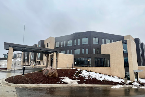 A modern building facade under a cloudy sky.