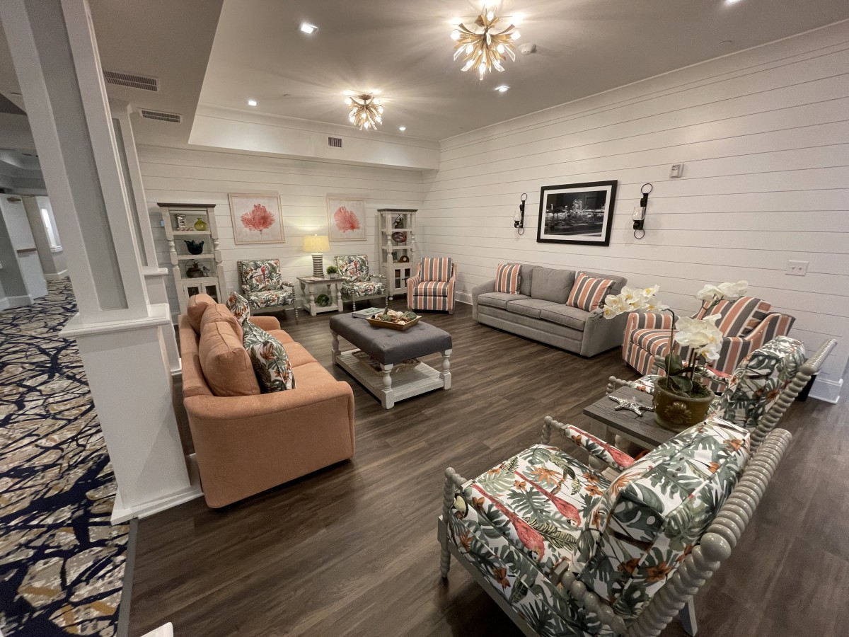 A cozy and beautifully decorated living room featuring modern lighting and a comfortable seating area.