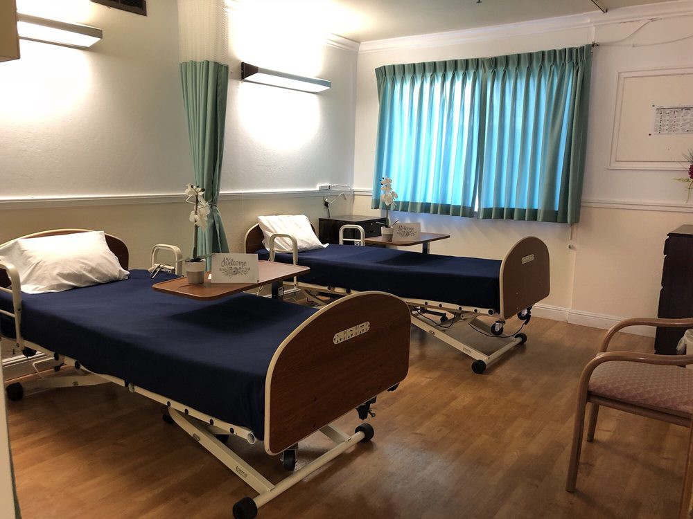A hospital room equipped with two beds and medical facilities.