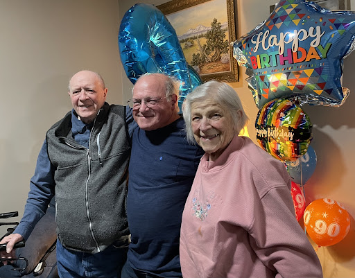 A joyful birthday celebration with friends, surrounded by colorful balloons.