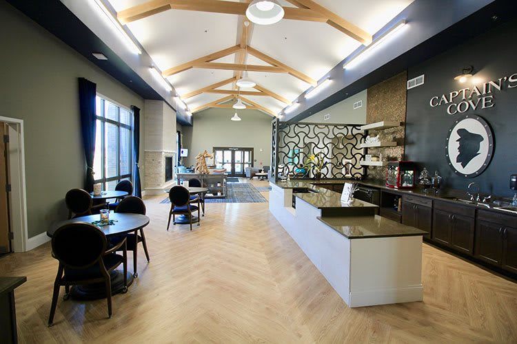 A modern cafe interior with wooden beams, comfortable seating, and a stylish counter.