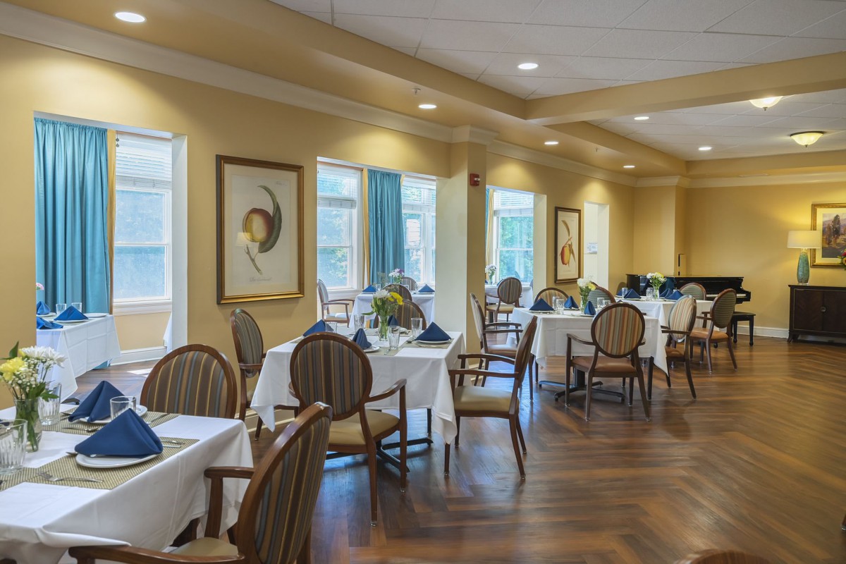 A well-appointed dining area with elegantly set tables and comfortable seating.