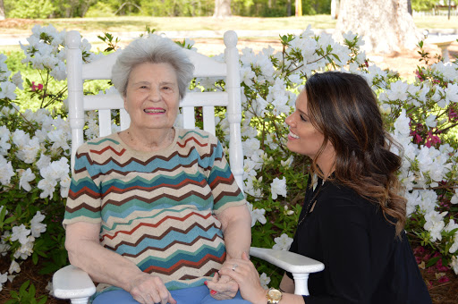 A joyful moment shared between a grandmother and her granddaughter in a beautiful outdoor setting.