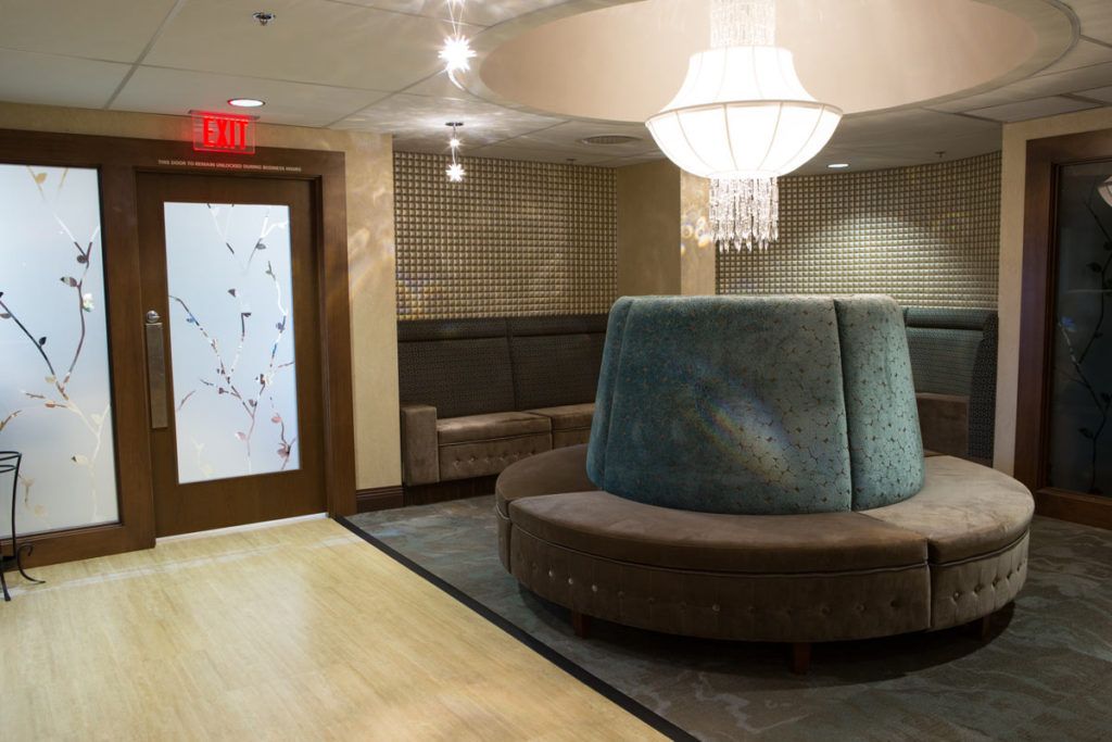 A modern lobby with stylish seating and a chandelier.