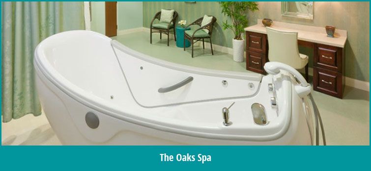 A serene setting at The Oaks Spa featuring a luxurious bathtub and peaceful decor.