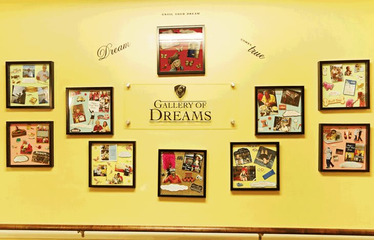 A wall display titled 'College of Dreams' featuring various framed collages and inspirational quotes.