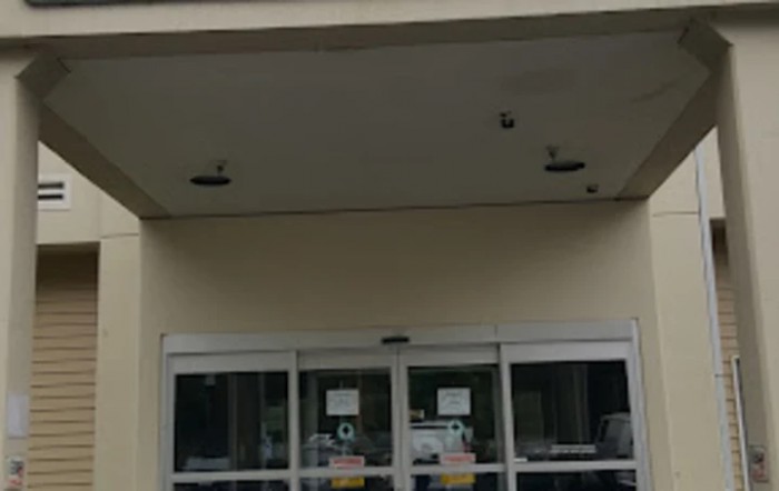 Entrance of a building with sliding glass doors.