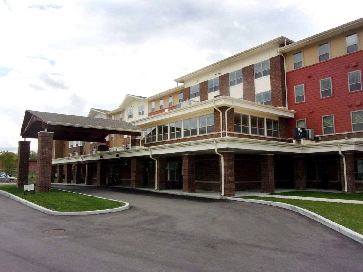 A modern hotel building with multiple floors and a covered entrance.