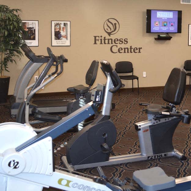 Interior of a fitness center featuring exercise bikes and an elliptical machine.