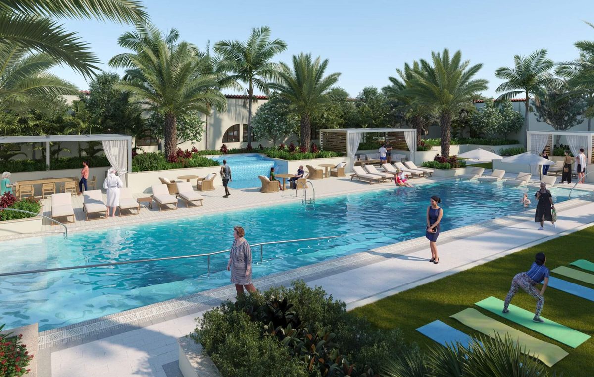 A luxurious outdoor pool area with palm trees and sun loungers, perfect for a relaxing vacation.