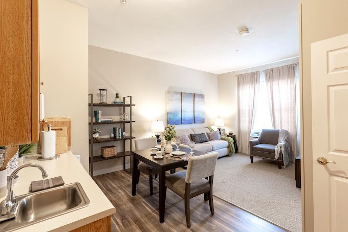 A modern apartment interior featuring a cozy living room and dining area with stylish decor.
