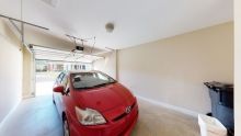 A red car parked inside a garage.