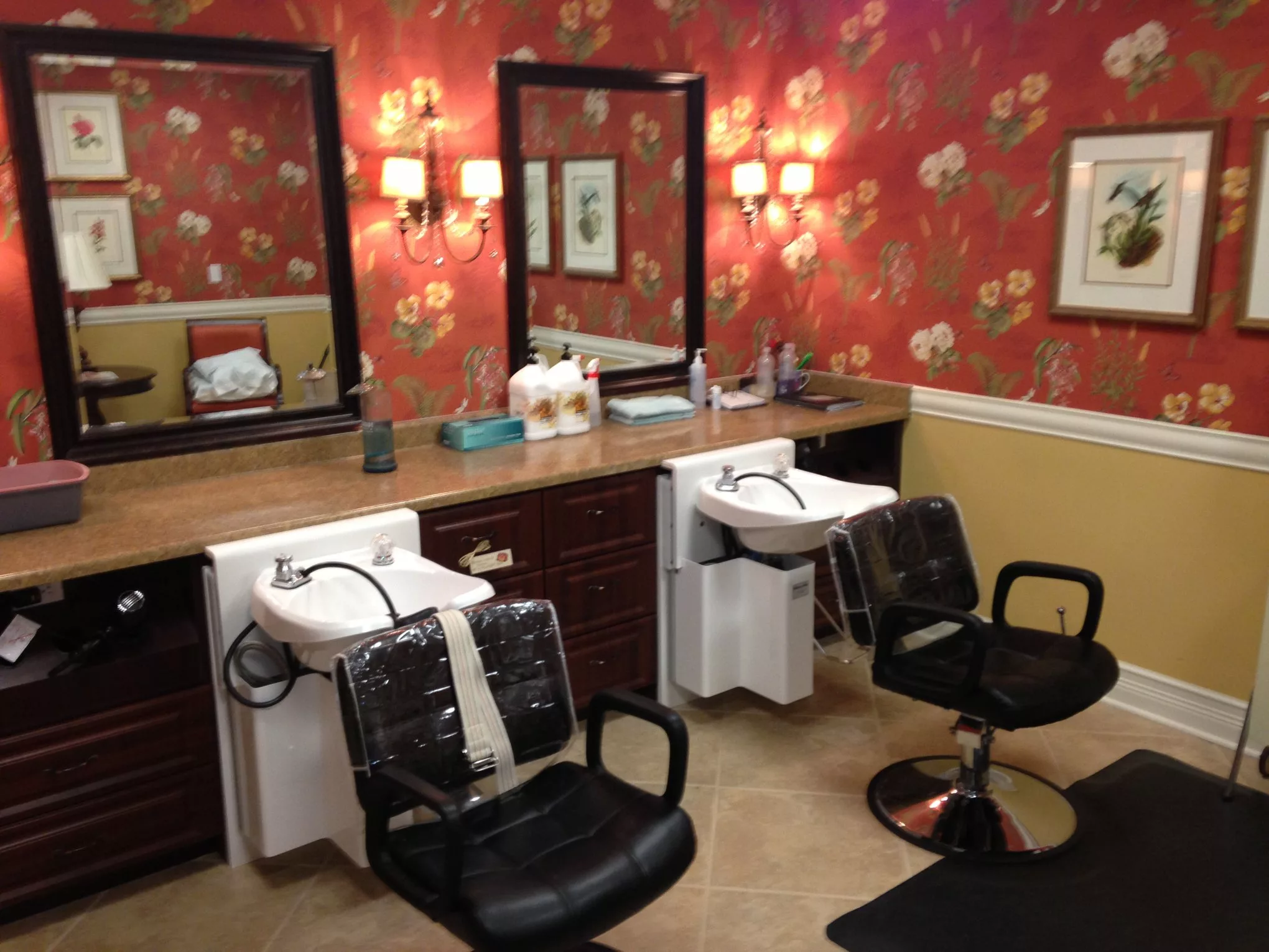 A stylish hair salon interior with two chairs, mirrors, and washing sinks.